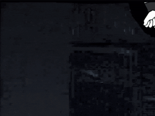 a dark room with a green arrow pointing to a white box