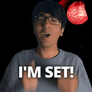 a man wearing glasses says " i 'm set " in front of a red light