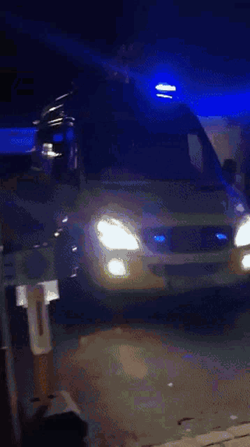 a yellow and green police van with blue lights on the side