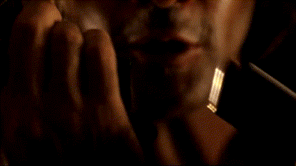 a close up of a man 's face with a very dark background