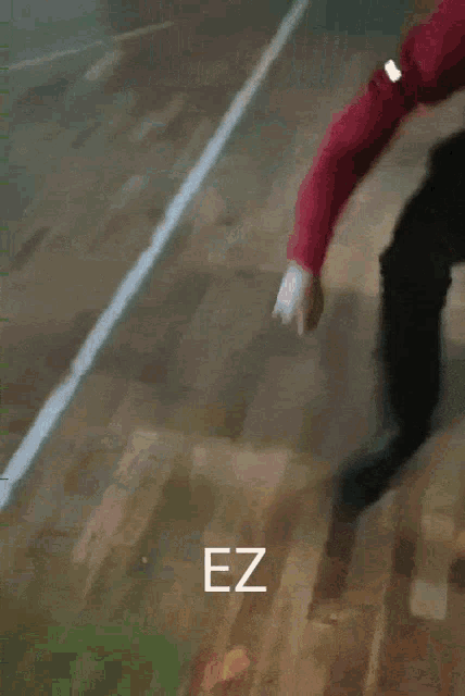 a person is standing on a wooden floor with the word ez written on the bottom