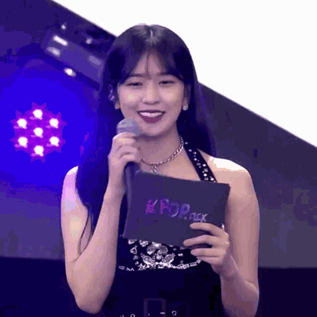 a woman is holding a card that says kpop rex