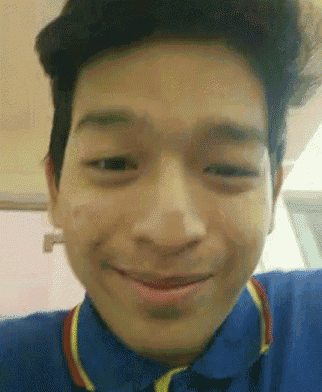 a close up of a man 's face with a smile on his face