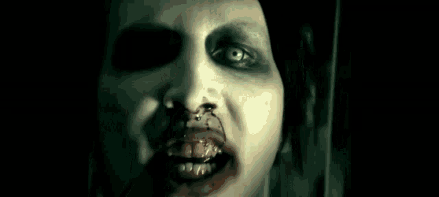 a woman with blood on her face is looking at herself in a mirror