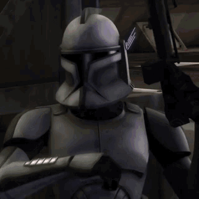 a clone trooper is holding a lightsaber in his hand
