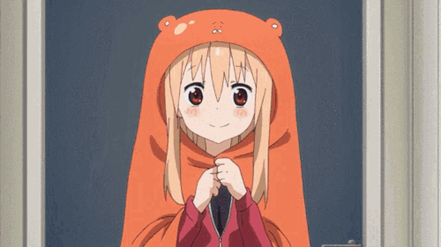a girl wearing a hooded sweater with a bear face on it