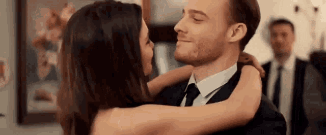 a man and a woman are dancing together in a room .
