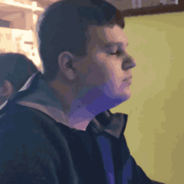 a blurry picture of a man 's face against a yellow wall