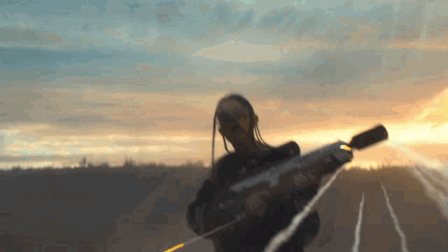 a person holding a gun with the letter a on the barrel