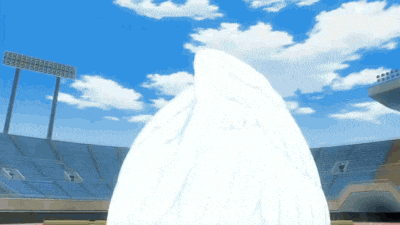a large white object is in the middle of a stadium with blue seats