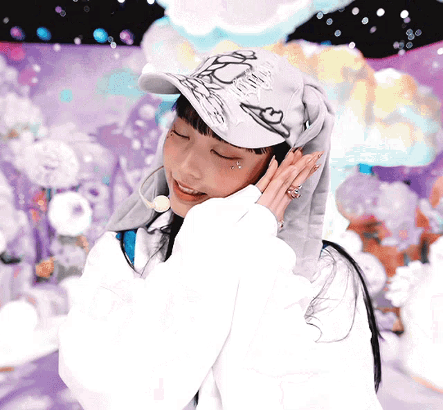 a woman wearing a hat with a butterfly on it is smiling