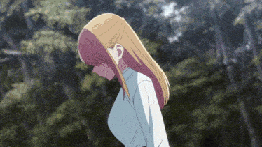 a girl with long blonde hair is standing in front of a forest