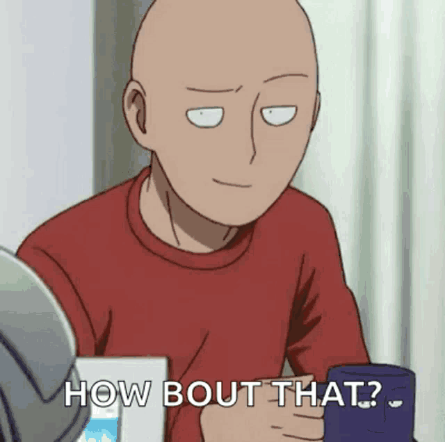 a bald man is sitting at a table holding a cup of coffee and a box of milk .
