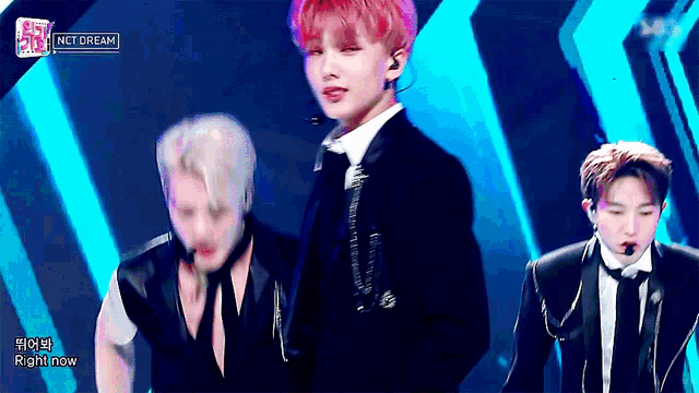 nct dream performs on a stage with a blue background