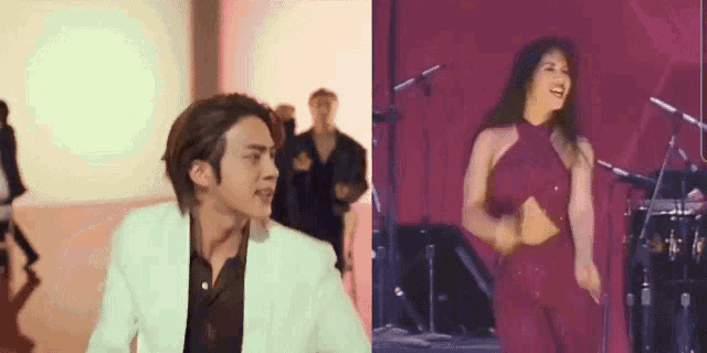 a man in a white suit is standing next to a woman in a red dress on a stage .