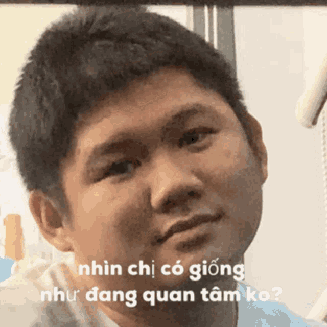 a close up of a man 's face with the words nhìn chị có giống như dang quan tâm ko