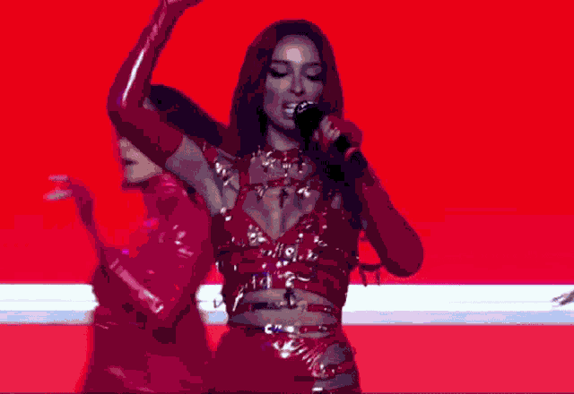 a group of women are dancing on a stage
