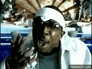 a man wearing sunglasses and a white headband is making a funny face