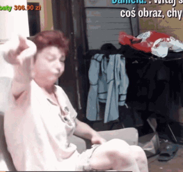 a woman is sitting in a chair with a sign that says baby 306.90 zl