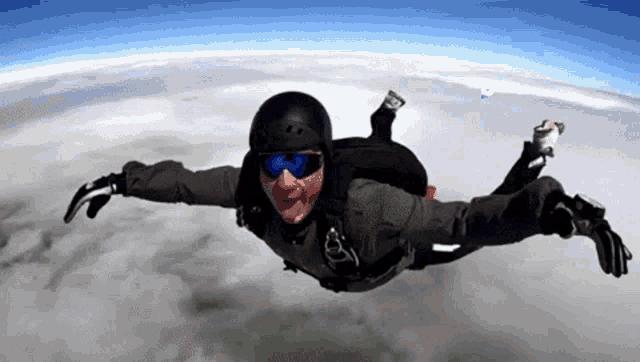 a man is flying through the air with a parachute on his back
