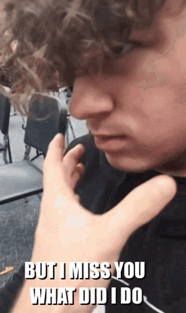 a young man with curly hair is being touched by another person 's hand and the caption reads but i miss you