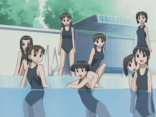 a group of girls in swimsuits are standing in a swimming pool
