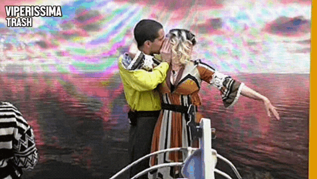 a man and a woman are kissing on a boat with the words viperissima trash on the bottom