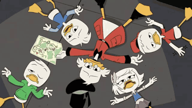a group of cartoon characters are laying on the ground