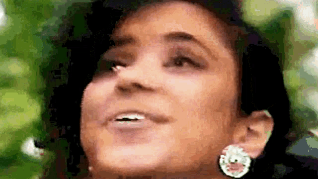 a close up of a woman 's face with a nose ring .