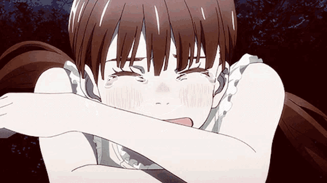 a girl with brown hair is crying and covering her face with her hand