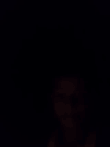 a blurry picture of a person 's hand in the dark