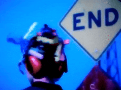 a man is looking at a sign that says end on it