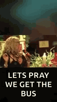 a woman singing into a microphone with the words let 's pray we get the bus below her .