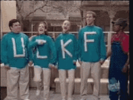 a group of people wearing blue sweaters with the letters lc kf on them