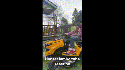 a man is riding a yellow lawn mower on a lawn .