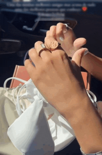 a close up of a person 's hand with a ring on it
