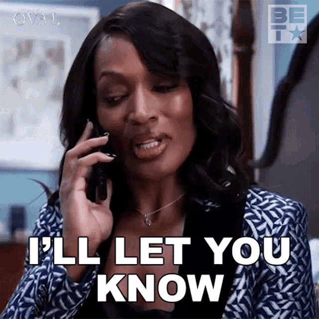 a woman is talking on a cell phone and saying i 'll let you know