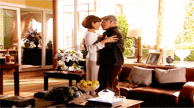 a man and woman kiss in a living room