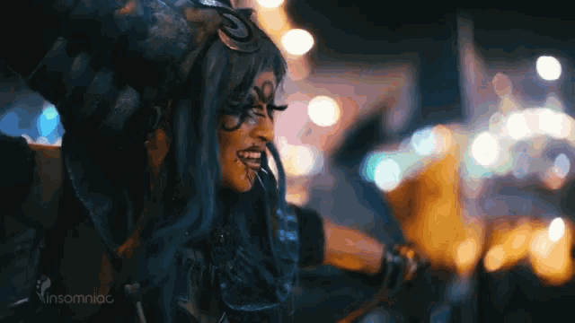a woman in a costume with insomniac on the bottom right