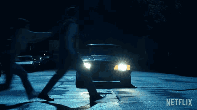 two people walking in front of a car with the netflix logo on the bottom