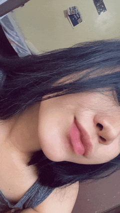 a woman with long black hair is taking a selfie