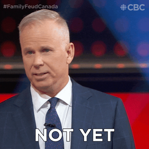 a man in a suit and tie says not yet on a red background