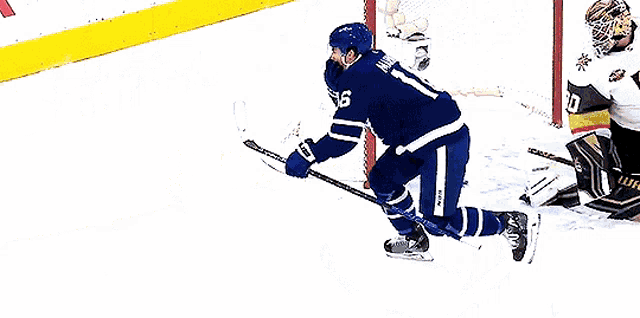 a hockey player with the number 16 on his jersey is standing on the ice