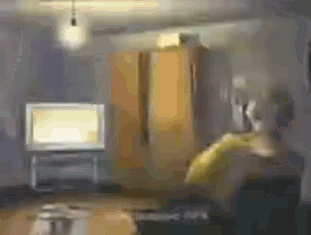 a blurry picture of a living room with a television and a couch