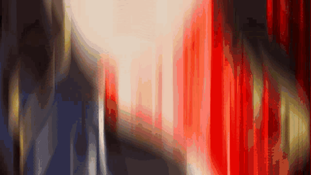 a blurred image of a red and white curtain with a black background