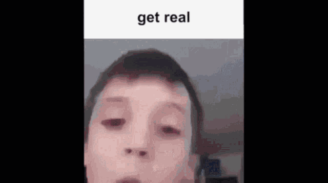 a close up of a young boy 's face with the words `` get real '' written on the bottom .
