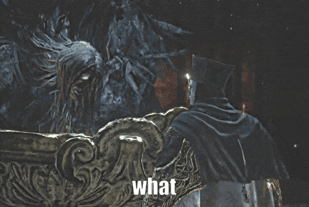a man in a hooded cape is standing in front of a statue that says what