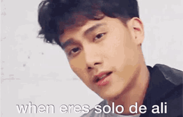 a close up of a man 's face with the words `` when eres solo de ali '' written on the bottom .