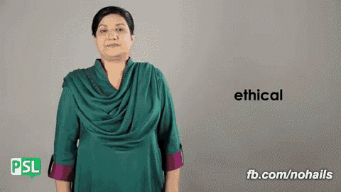 a woman in a green dress is signing the word ethical in sign language .