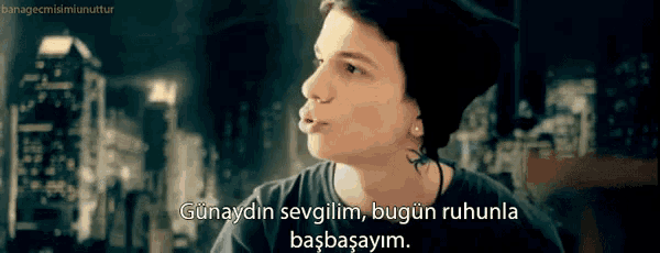 a young man wearing a black shirt and a beanie says " günaydin sevgilim "